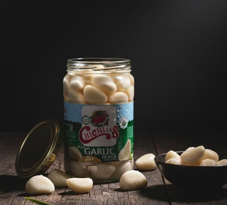 White Garlic Pickle in Glass Jar Packaging with authentic taste, high quality, long shelf life, and a healthy choice for everyday meals.
